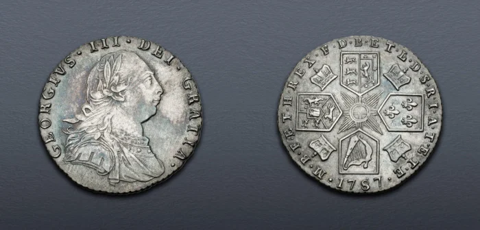 A George III silver shilling of 1787, obverse and reverse, showing the King's portrait and the crowned quartered shield of arms.