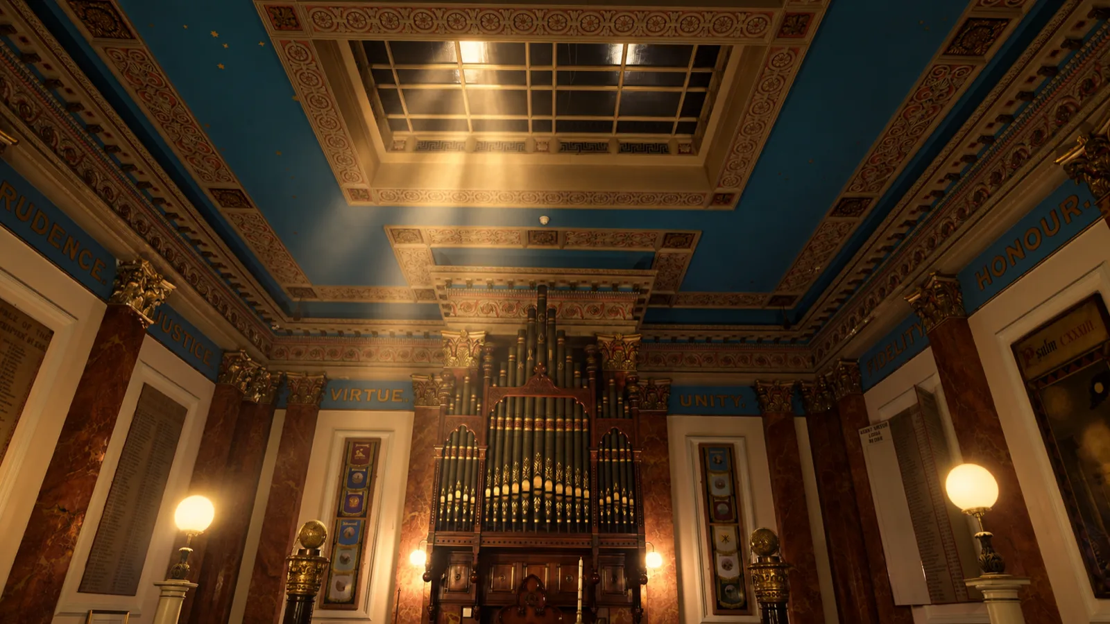 The painted ceiling above the grand organ, lit by a skylight, with the words Prudence, Justice, Virtue, Unity, Fidelity and Honour inscribed on the entablature.